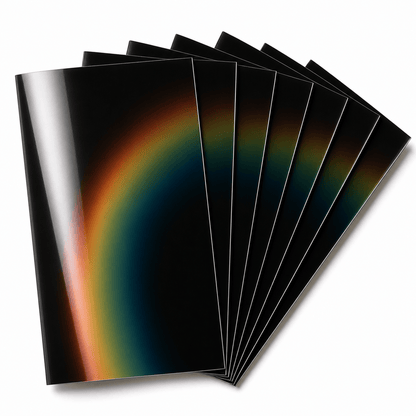 Seven gloss liquid crystal sheets fanned out on a white background, displaying a smooth iridescent gradient from amber to deep teal across the full temperature range